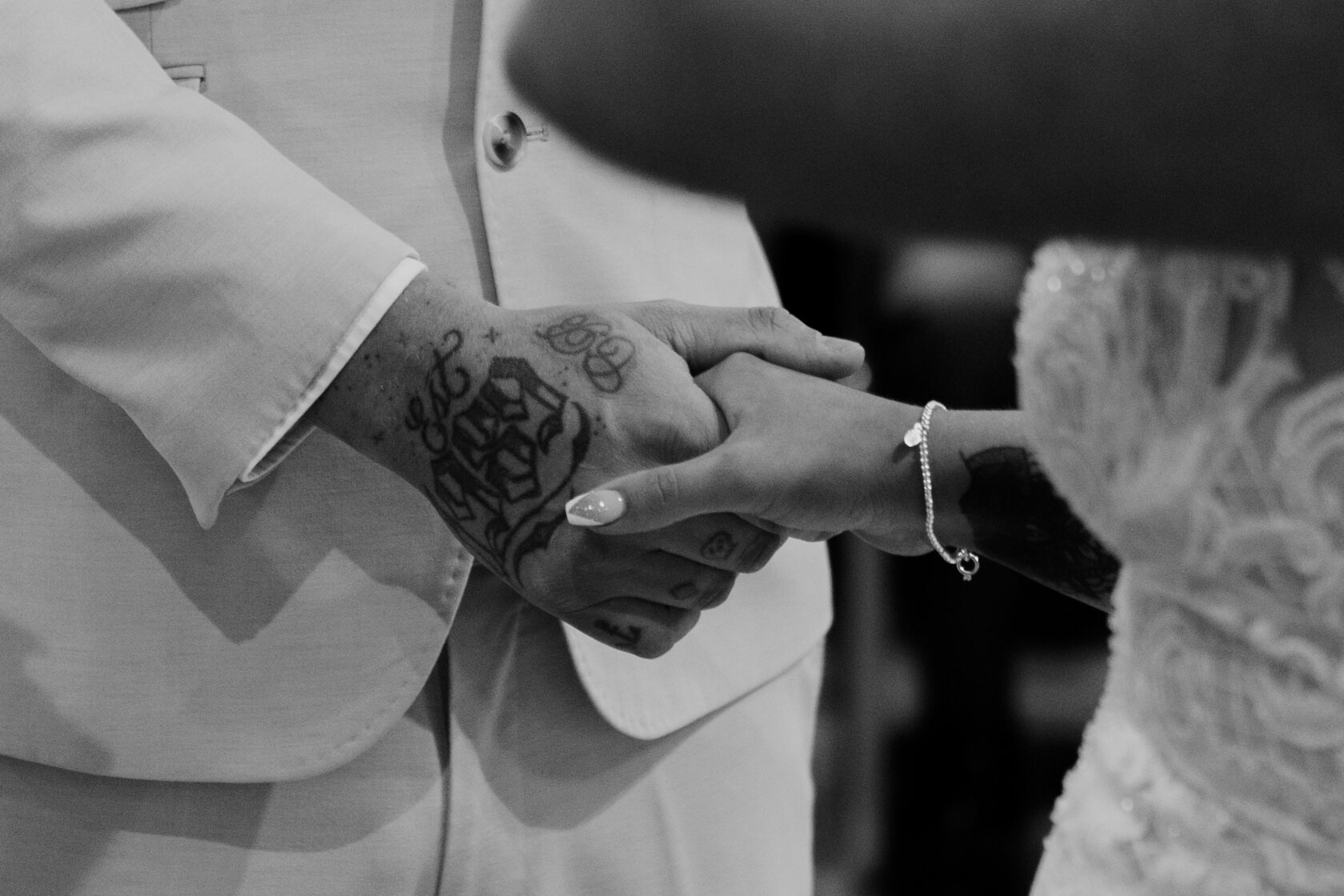 A beautifully arranged bridal bouquet featuring orange flowers, a delicate white veil, a comb, and elegant white shoes with bows, Shot for Lydia Turner